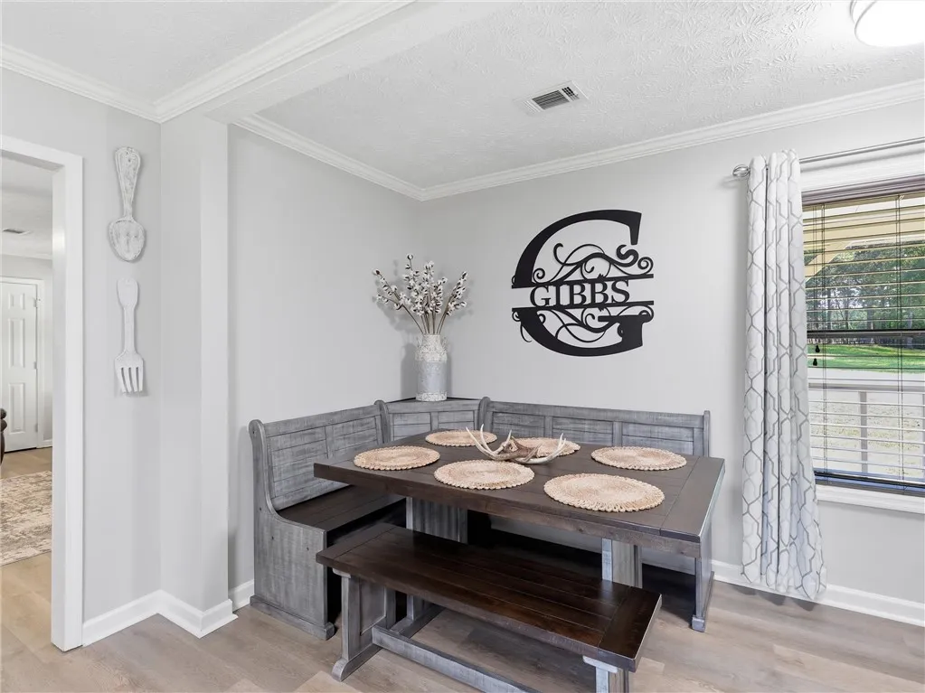 A well-lit breakfast area offers comfortable bench seating and a view of the outside.