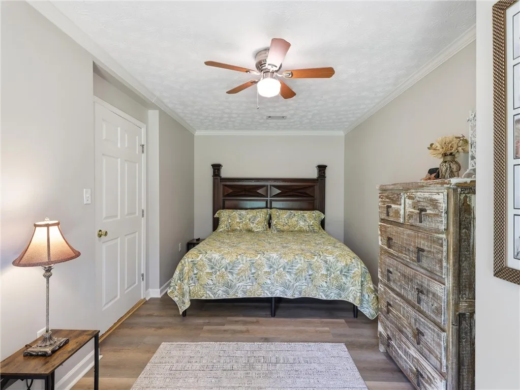 Comfortable bedroom with warm flooring and ample space for relaxation.