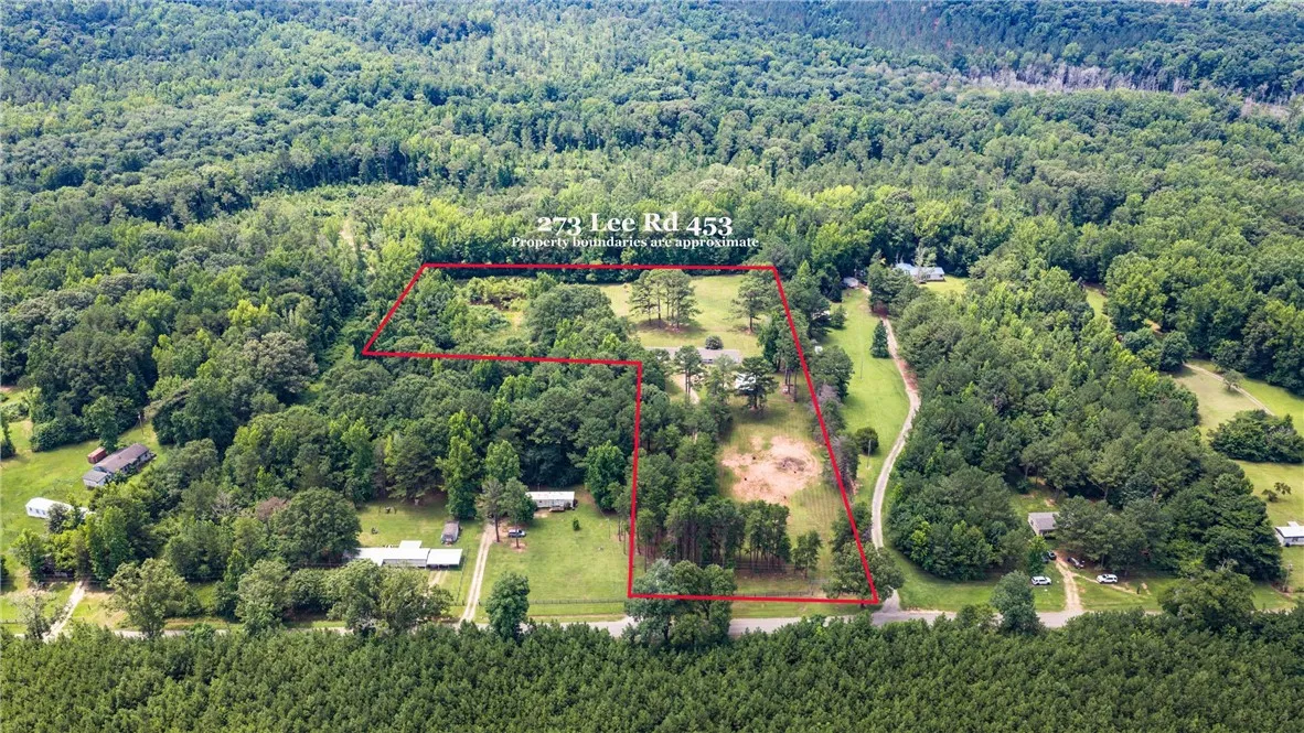 An aerial perspective reveals a vast, tree-lined rural lot with potential building sites.