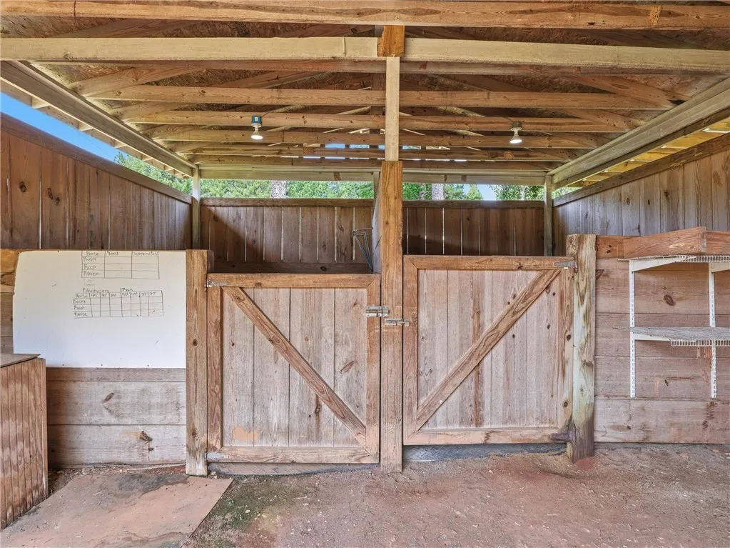 Functional barn structure with robust wooden stalls ready for equine companions.