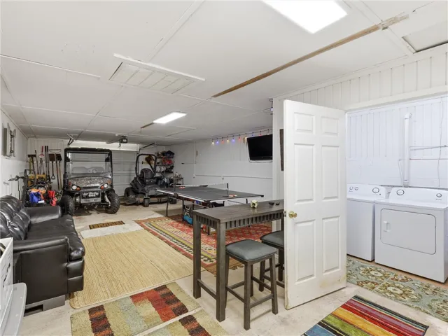 A versatile garage space ready for recreation or extra storage, complete with laundry facilities.