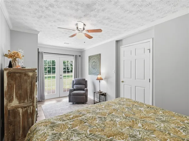 French doors open to outdoor serenity, creating a private retreat within this peaceful bedroom.