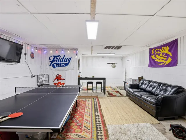 A vibrant game room offers space for recreation and relaxation, perfect for entertaining.