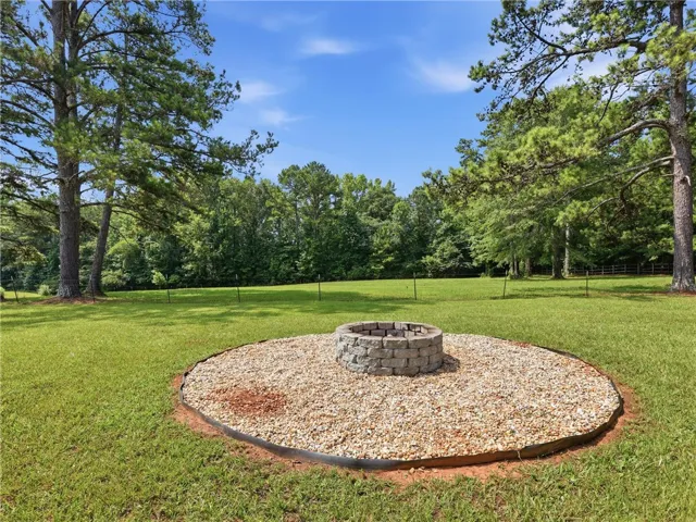 Enjoy evening gatherings around this charming backyard fire pit.