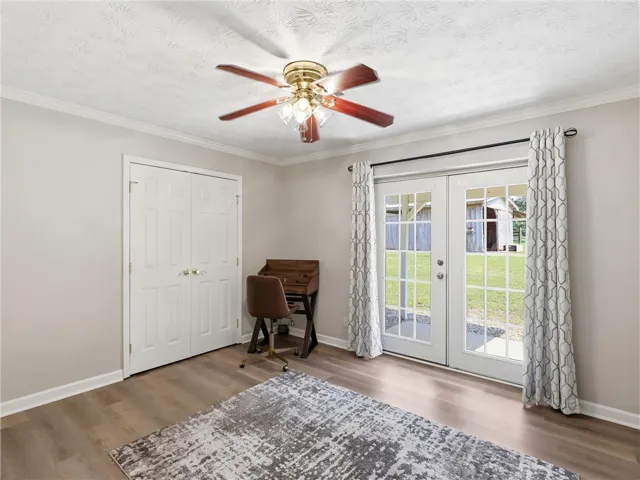 French doors open to a refreshing outdoor vista, bringing light and air into this versatile space.