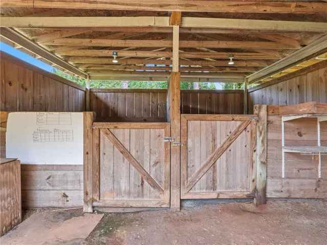 Functional barn structure with robust wooden stalls ready for equine companions.