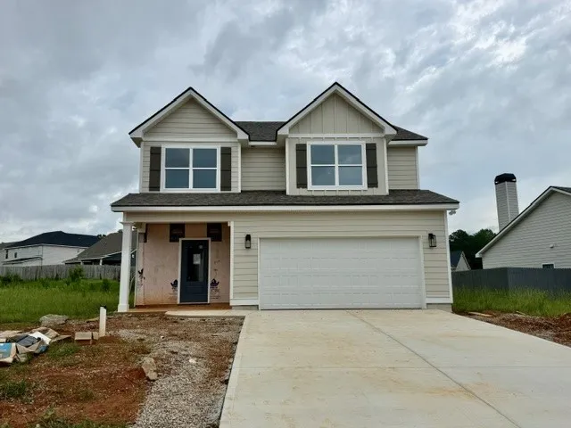 A new construction home with an inviting front facade and a spacious two-car garage.