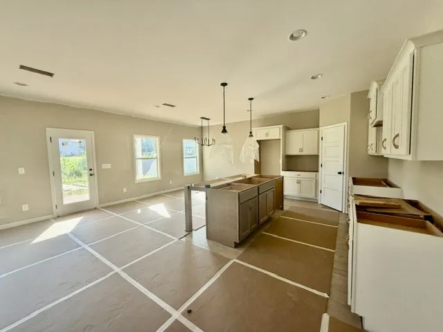 A new construction kitchen showcases ample cabinetry and an inviting open-concept layout.