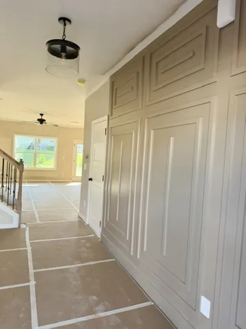 Board and batten detailing elevates the entry, leading to an inviting open living space.