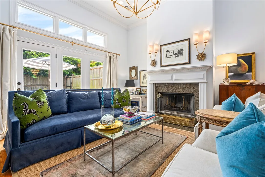 A refined living space showcasing a grand fireplace and direct access to outdoor living.