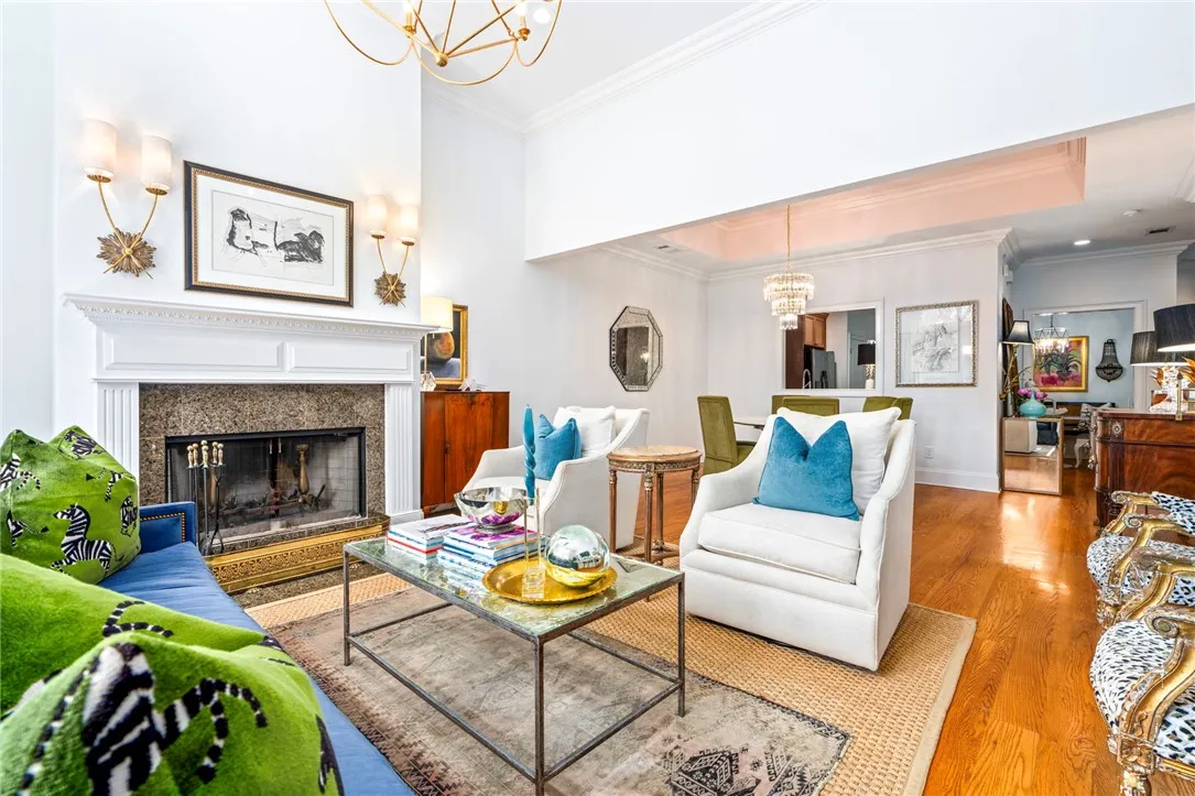 A refined living space with rich hardwood flooring and a stately fireplace, ideal for elegant entertaining.