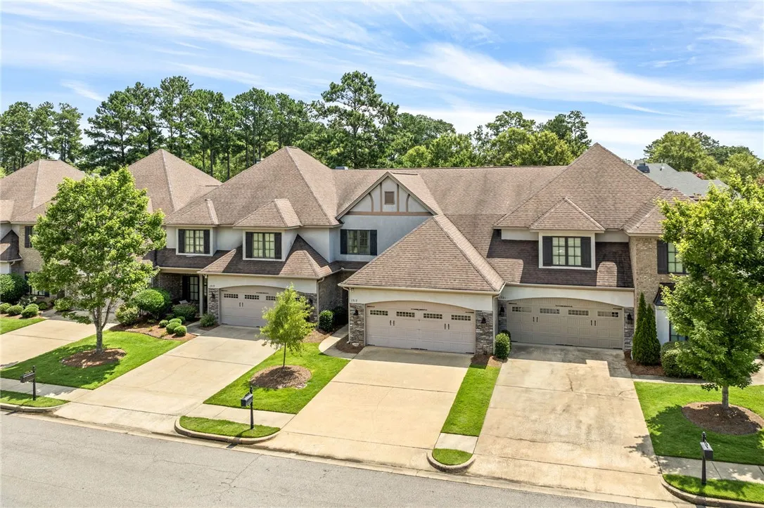 Attached garage townhomes with inviting concrete driveways and lush green lawns await.