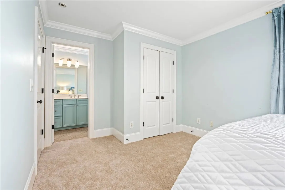 Well-lit sleeping quarters with a dedicated closet and en-suite bathroom access.