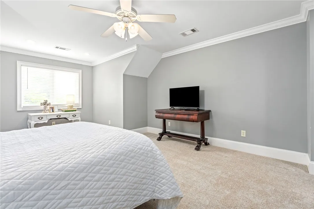 Plush carpet and soft lighting create a peaceful retreat within this welcoming space.
