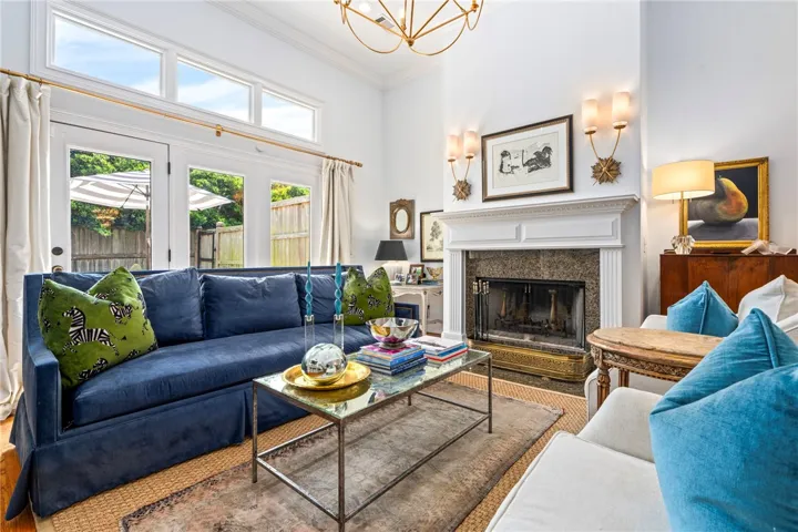 A refined living space showcasing a grand fireplace and direct access to outdoor living.