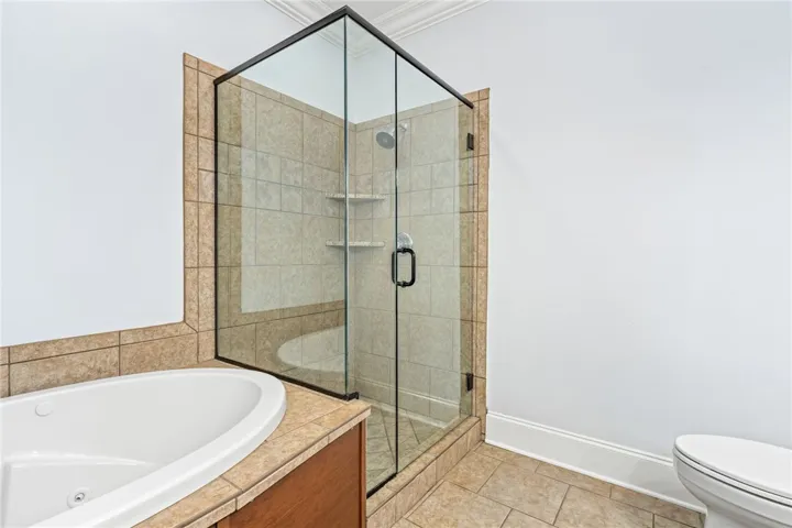 Indulge in a relaxing soak within this well-appointed bathroom featuring a separate shower and inviting tub.