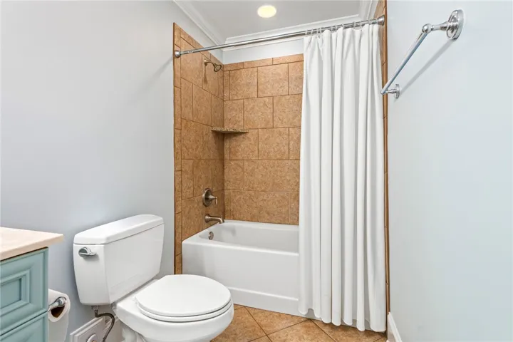 Clean, practical bathroom with a tub and tiled shower enclosure.