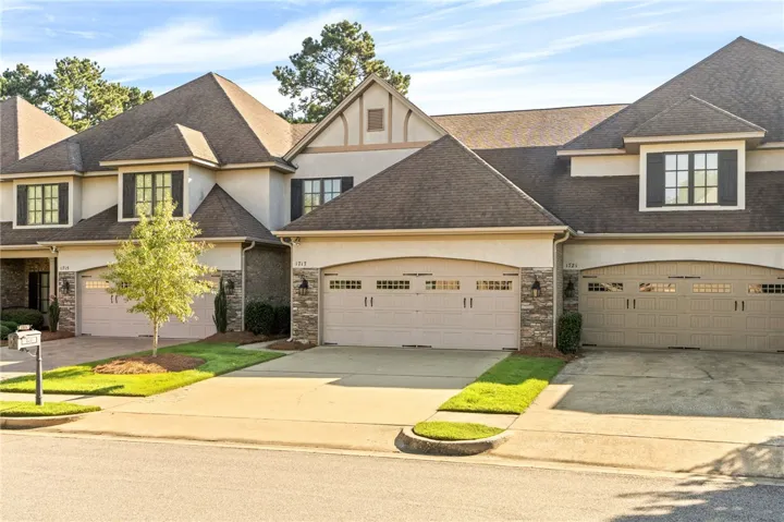 A classic exterior displays detailed stone accents and multiple multi-car garages.