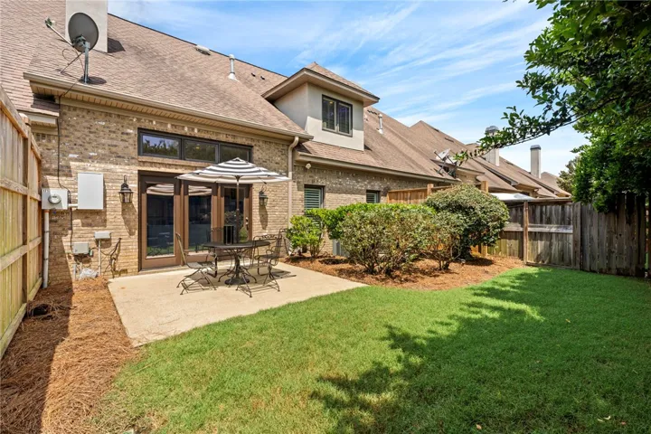 An inviting backyard patio and lawn for serene outdoor moments.