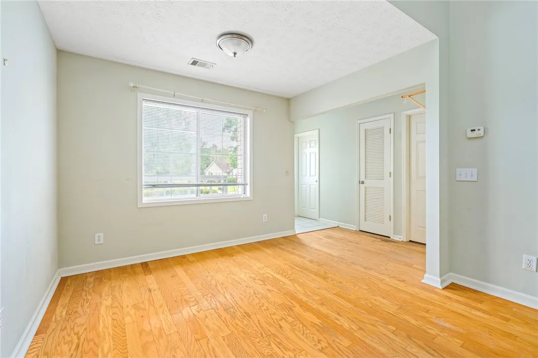 Hardwood floors and generous natural illumination define this versatile interior space.