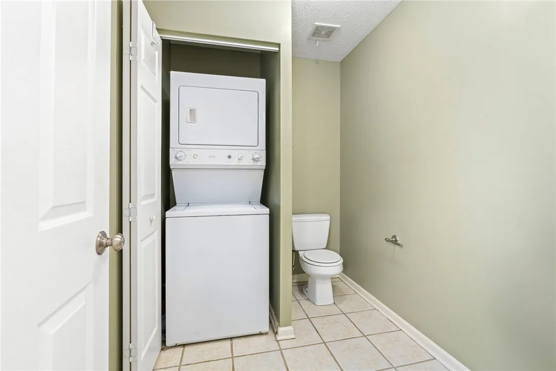 A compact laundry and bath area optimizes functionality within limited square footage.