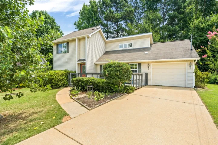 A well-maintained facade with neat landscaping and a spacious driveway welcomes you home.