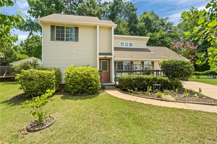A classic exterior with inviting curb appeal, featuring well-maintained siding and mature landscaping.