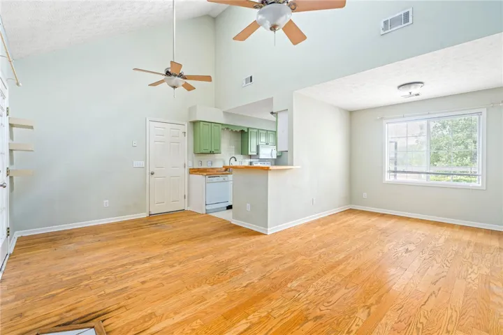 Vast hardwood floors and high ceilings define this bright living space with an integrated kitchen.