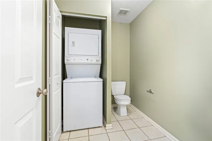 A compact laundry and bath area optimizes functionality within limited square footage.