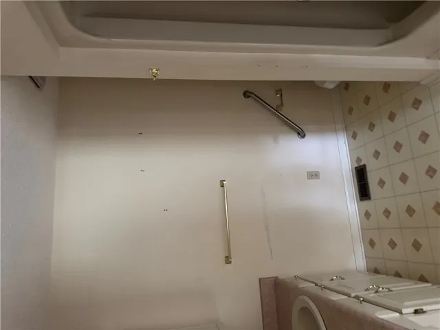 A well-maintained bathroom with tiled flooring and a built-in tub.