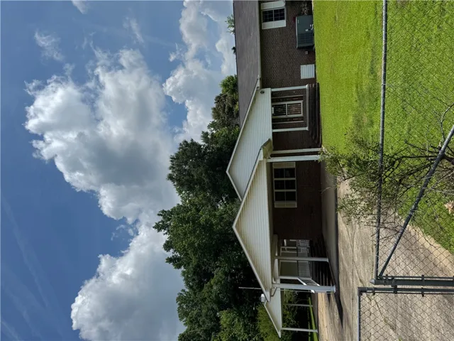 A classic brick exterior with white siding and covered porch welcomes you home.