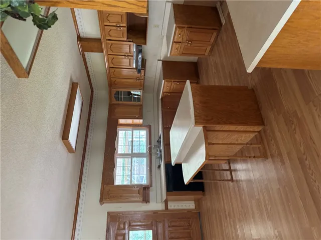 A functional kitchen with wood cabinetry and an integrated sink provides ample space for culinary endeavors.