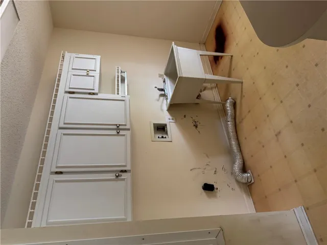 Ample storage solutions elevate the functionality of this dedicated laundry space.