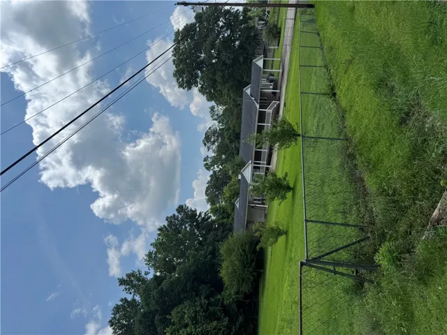 A classic residential exterior offers a pleasant view of the home and its spacious yard.