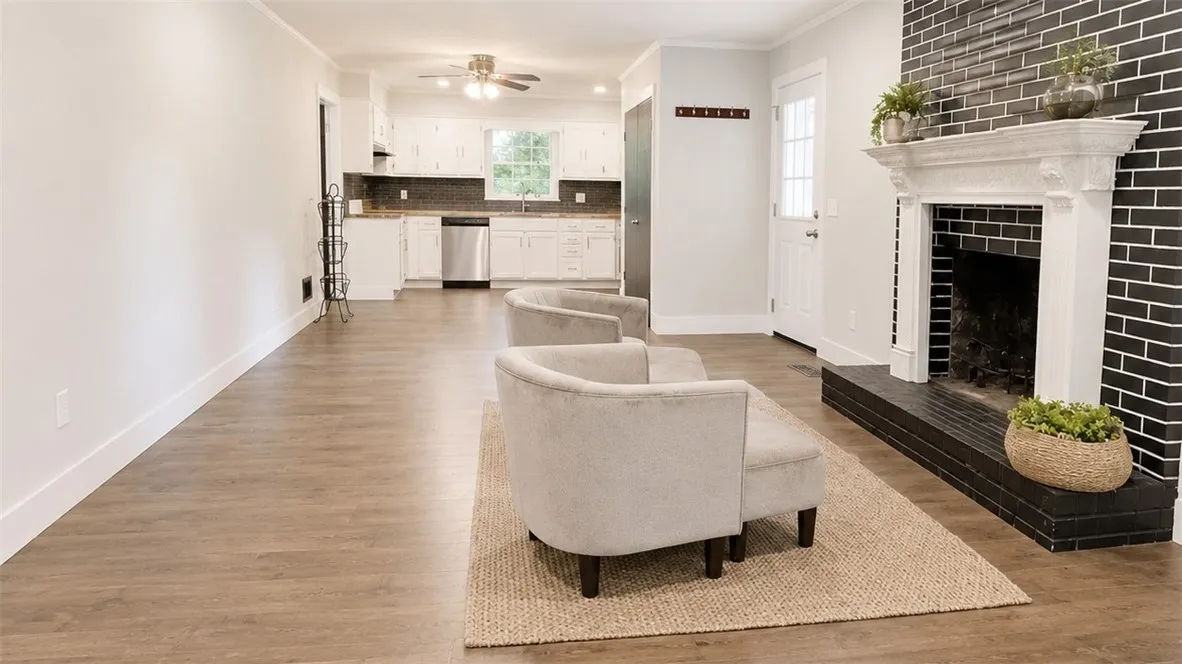A striking black brick fireplace anchors this inviting open-concept living space.