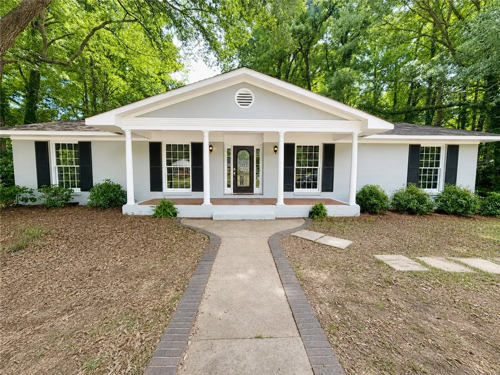 A well-maintained facade with an inviting front porch welcomes you home.