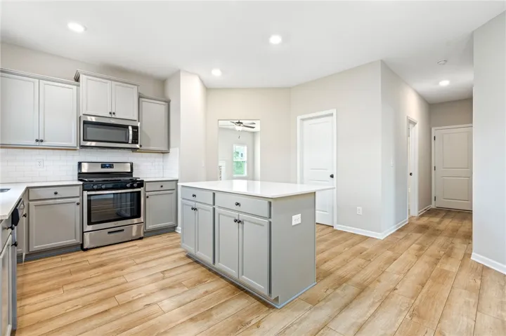 Modern kitchen with an inviting island and sleek stainless steel appliances.