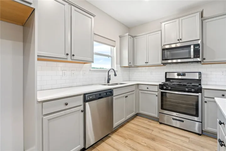Culinary adventures await in this kitchen featuring abundant cabinetry and a complete suite of stainless steel appliances.