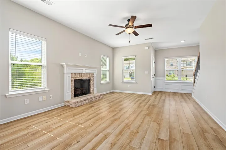 A cozy living space features an inviting fireplace and natural light from multiple windows, perfect for quiet evenings.