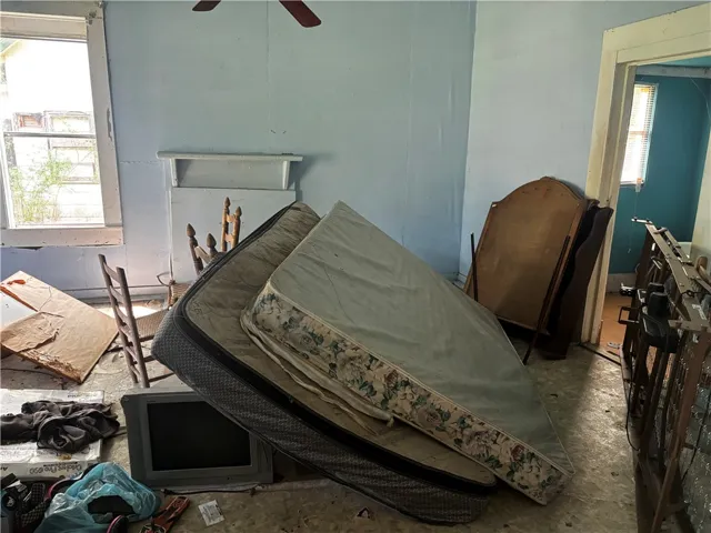 A window-filled room with potential, awaiting transformation.