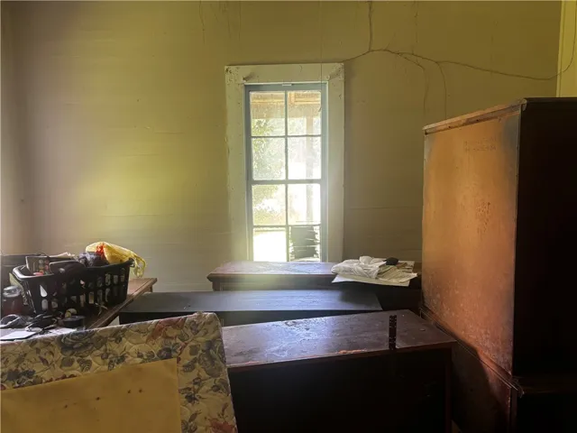 A window bathes this room in natural light, offering potential for restoration.
