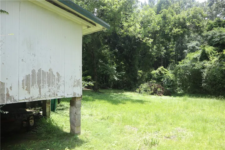 A verdant, undeveloped lot offers potential for new construction amidst a natural setting.
