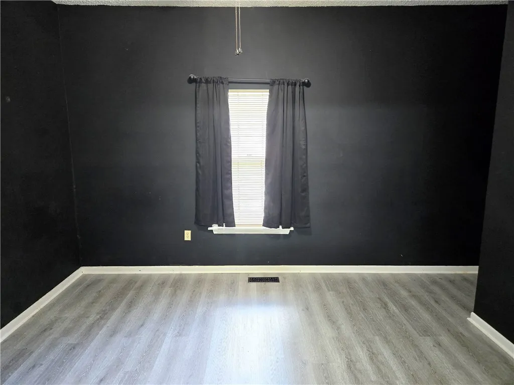 Newly installed laminate flooring enhances this room's ready-to-personalize interior.