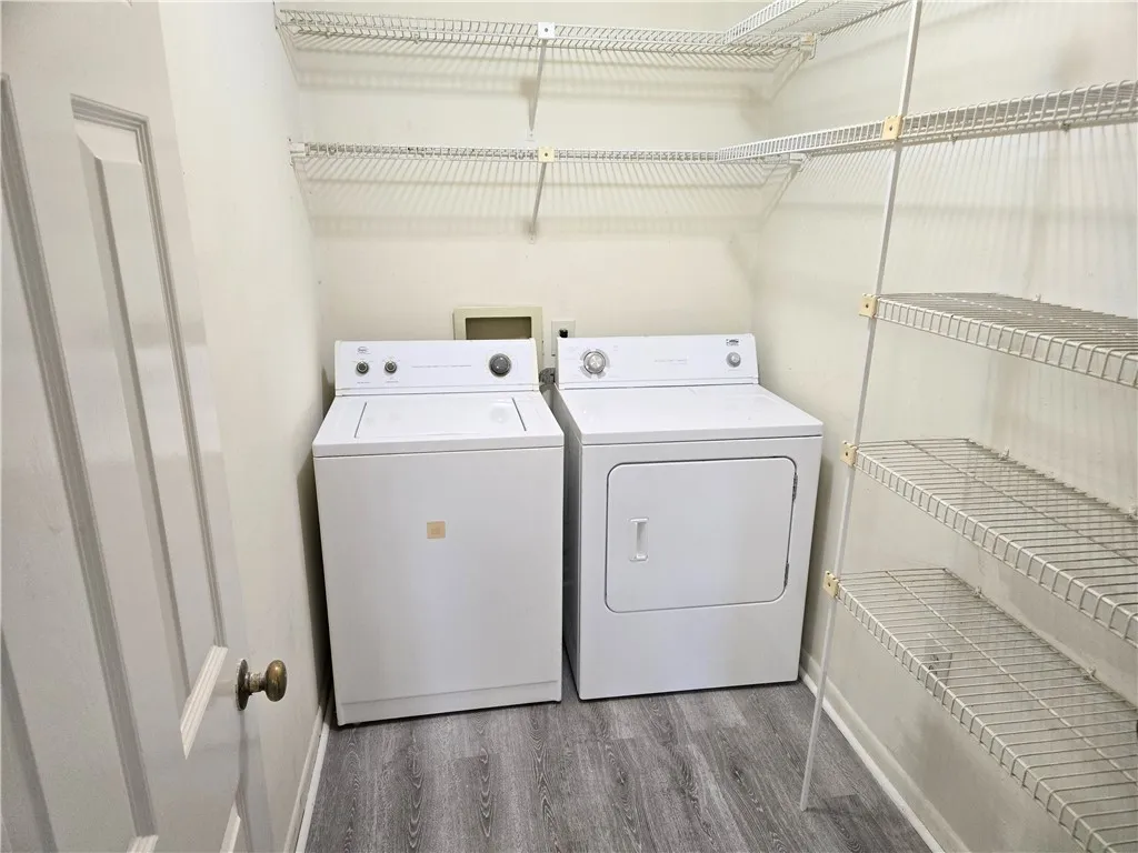 A well-organized laundry area offers practical wire shelving and modern appliances for efficient chores.