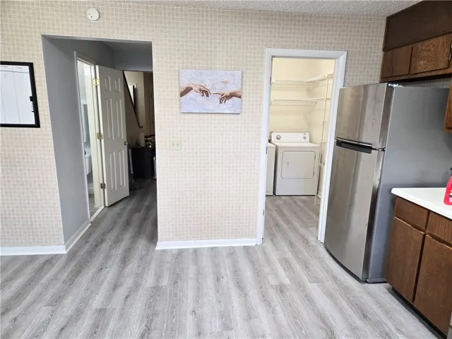 Smartly designed laundry nook and kitchen appliances offer functional living spaces.
