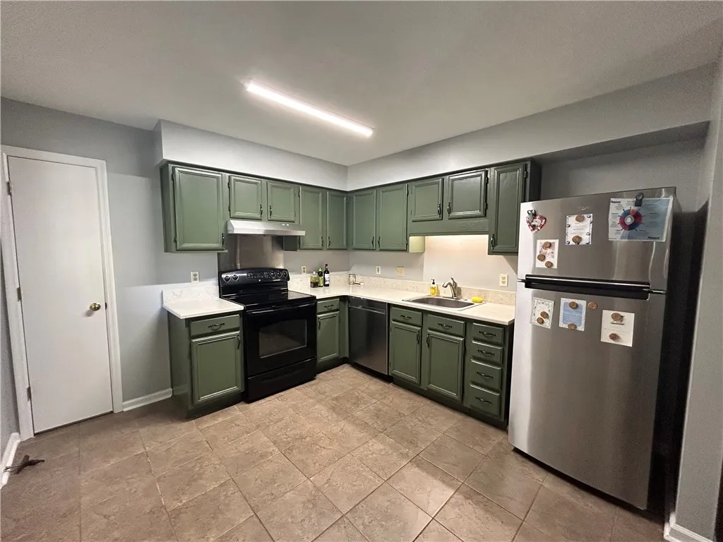 Functional kitchen with ample cabinet space and essential appliances, ready for culinary endeavors.