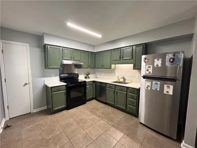 Functional kitchen with ample cabinet space and essential appliances, ready for culinary endeavors.