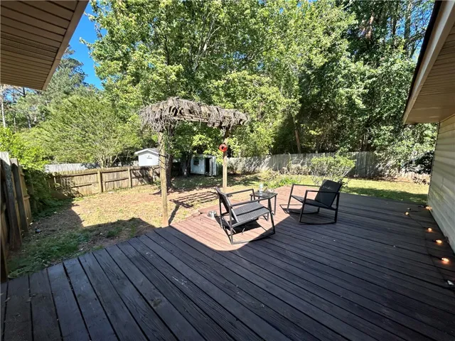 A spacious backyard with a generous deck offers ample room for relaxation and outdoor enjoyment.