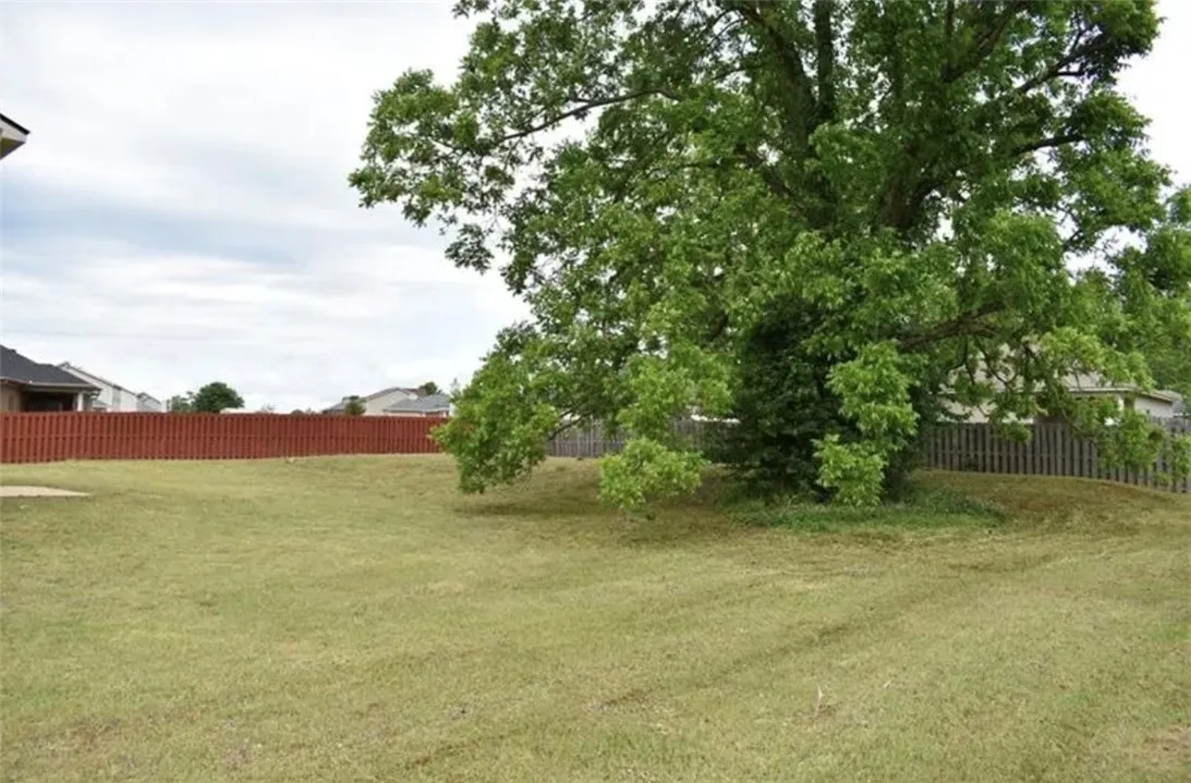 A spacious, well-maintained yard offers ample room for outdoor activities.
