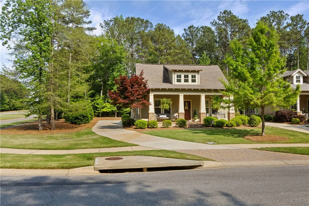 A welcoming front porch and manicured lawn invite you into this charming residence.